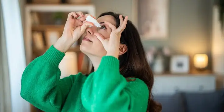 Giving eye drops as the preoperative care of eye surgery.