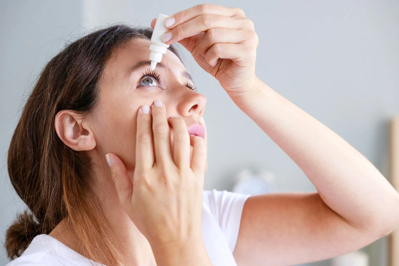 Giving eye drops after SICS Eye Surgery for eye care.