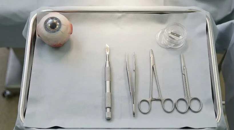A top-down view of an ophthalmic surgical tray with instruments and an eye model prepared for a procedure - Keratotomy Eye Surgery - 2